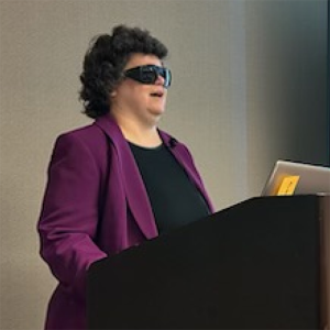 angela standing at a podium